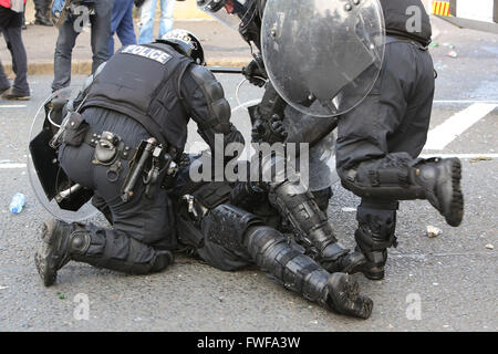 Armed police officers watch Loyalists during trouble in north Belfast after a sustained attack on police in the Woodvale area of Stock Photo