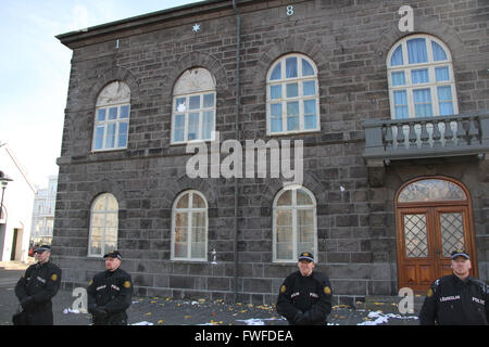 Reykjavik, Iceland. 4th Apr, 2016. Policemen stand guard in front of the parliament building during a protest in Reykjavik, capital of Iceland, on April 4, 2016. Thousands of Icelanders gathered in front of the parliament on Monday evening to express their anger against the government following the release of the so-called 'Panama Papers', which suggest Icelandic prime minister Sigmundur David Gunnlaugsson and other two cabinet members have ties to offshore companies. Credit:  Xie Binbin/Xinhua/Alamy Live News Stock Photo