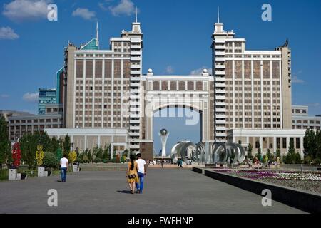 The headquarters of the state energy company 'KazMunayGaz' in Kazakhstan's young capital Astana. In the background the 97 meter high Bayterek Tower, a landmark of Astana. Picture taken 2013-06-21. Stock Photo