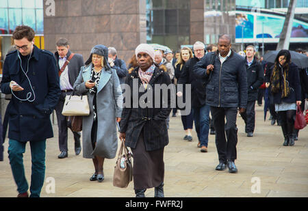 London, UK. 6th April, 2016.  City workers on London Bridge on way to work on the first day of the new tax year, on a wet and dull morning. Credit:  Dinendra Haria/Alamy Live News Stock Photo