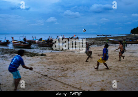 Playing football on the beach. Fishers village. Phi Phi don. Relax Beach. Phak Nam Bay. Thailand. Asia. Phi Phi Don island. Krab Stock Photo