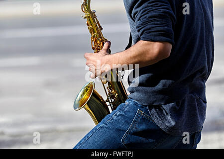 Young adult man playing a saxophone Stock Photo