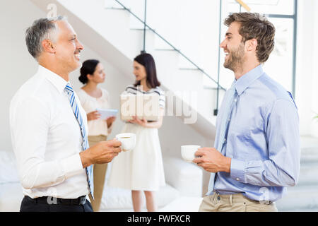 Businessmen interacting during a break time Stock Photo