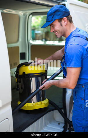 Happy janitor cleaning the car Stock Photo