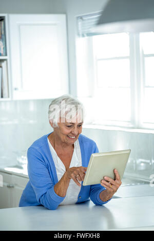 Happy senior woman using tablet pc Stock Photo