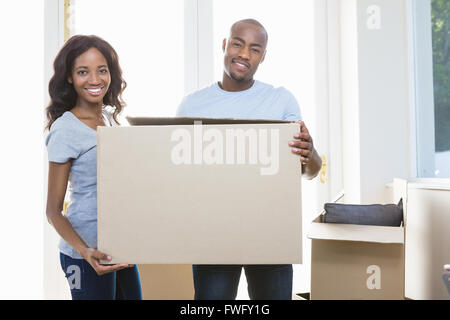 Young couple holding carton boxes Stock Photo