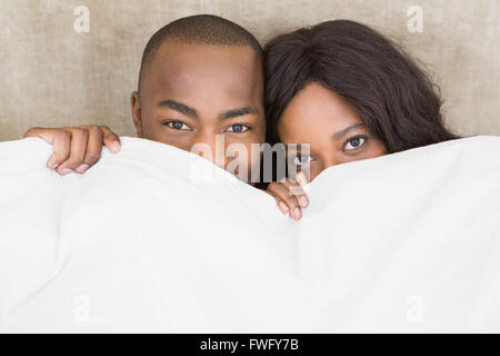 Portrait of young couple holding blanket Stock Photo