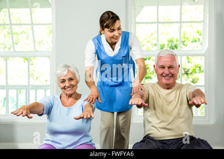 Nurse assisting senior man and woman Stock Photo