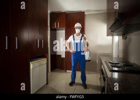 Portrait of pesticide worker with hand on hip Stock Photo