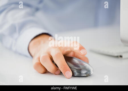 Mid-section of mans hand working on computer Stock Photo