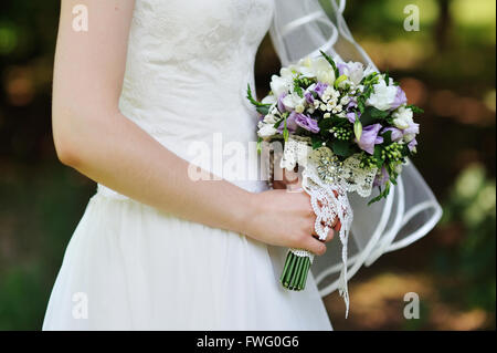 Wedding bouquet in hands of the bride Stock Photo