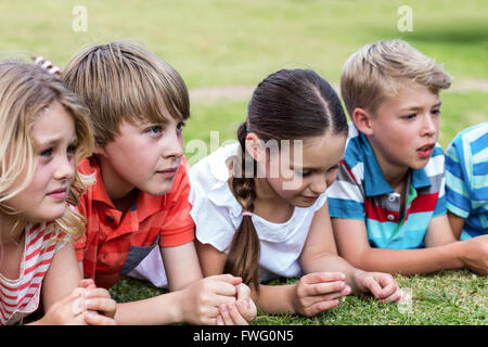 Children lying on grass Stock Photo