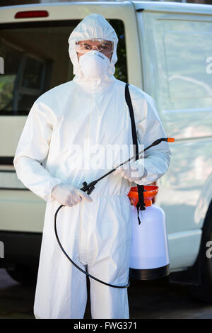 Pest control man standing behind a van Stock Photo