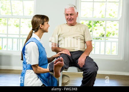 Nurse assisting senior man Stock Photo