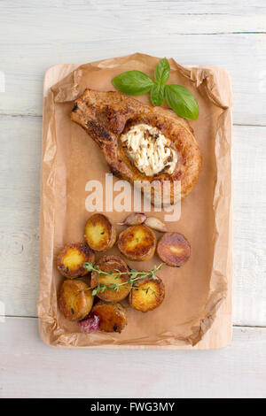 Steak and baked potatoes with garlic Stock Photo