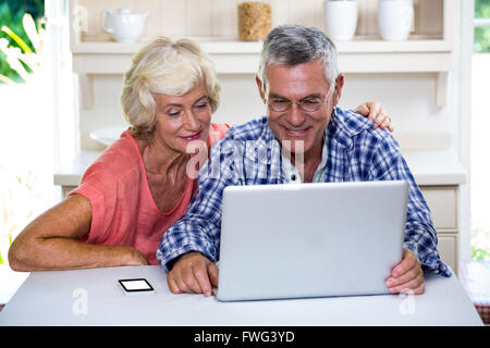 Senior couple using laptop at home Stock Photo