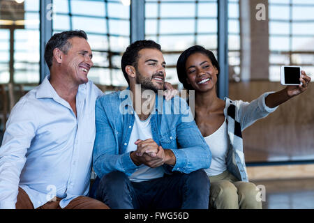 Happy Colleagues taking selfie Stock Photo