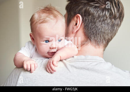 Happy father holding newborn baby in his arms