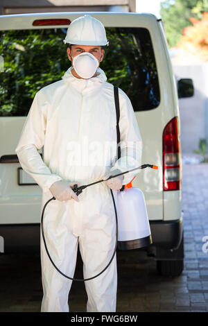 Pest control man standing behind a van Stock Photo