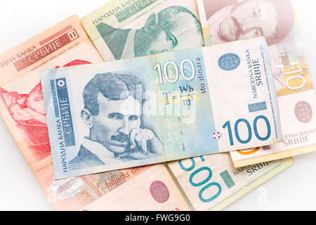 100 Serbian dinar bill on top of different Serbian dinar bills scattered on white background. Stock Photo