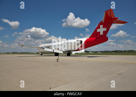 Borispol, Ukraine - July 5, 2014: Helvetic Airways Fokker-100 passenger plane taxiing to the terminal after landing - rear view Stock Photo