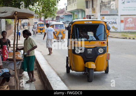 Tuk Tuk Yellow Taxi Vehicles.  Sambava.  Sava Region. Northeast Madagascar. Stock Photo