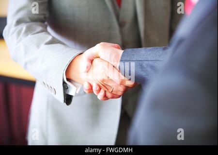 UK Business men in the city shake hands to seal the contract Stock Photo