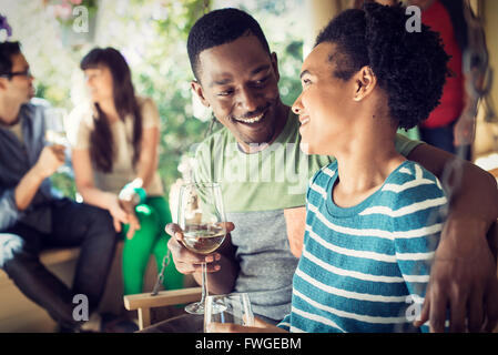 A group of friends, men and women at a house party, a couple side by side. Stock Photo