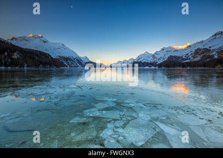 Sheets of ice on the surface of Lake Sils in a cold winter morning at dawn, Engadine, Canton of Graubunden, Switzerland, Europe Stock Photo