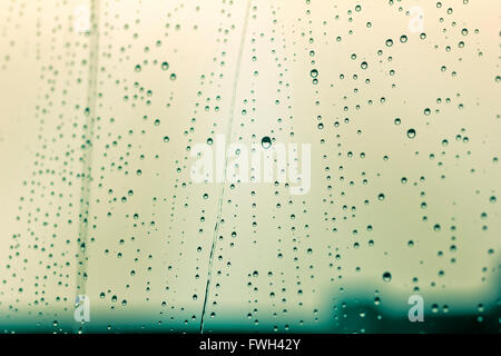 Rain drops on glass in blue tones Stock Photo