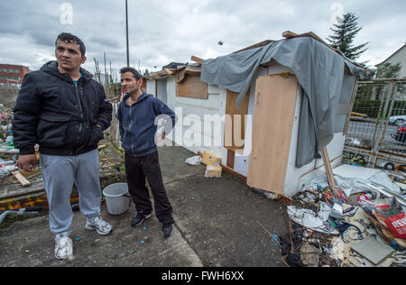 Romani Milan (names changed upon request) and Drago pose next to their wooden shack on a demolition site in Frankfurt am Main, Germany, 05 April 2016. Some 30 people from Romania reside in makeshift huts at this location in abysmal hygenic conditions. Photo: BORIS ROESSLER/dpa Stock Photo
