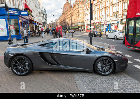 London, UK.  5 April 2016.  A McLaren MP4-12c with Monaco numberplates drives into traffic.  Supercars are in Knightsbridge as the 'season' for Middle Eastern owned supercars is about to commence. Credit:  Stephen Chung / Alamy Live News Stock Photo