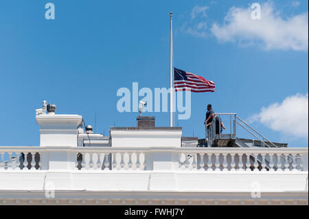 Washington DC, USA. 12th June, 2016. The American flags that fly over the White House in Washington, DC are lowered to half staff following United States President Barack Obama's remarks to reporters in the Brady Press Briefing Room in Washington, District of Columbia, U.S., on Sunday, June 12, 2016, about the deadly shooting the night before in a gay nightclub in Orlando FL. Approximately 50 people were killed and at least 53 more were injured in what appears to be the deadliest mass shooting in U.S. history. Credit: Pete Marovich / Pool via CNP - NO WIRE SERVICE - © dpa picture alliance/Alam Stock Photo
