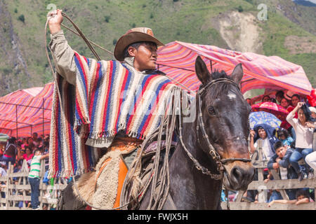 Banos, Ecuador - 30 November 2014: Young Latin Cowboy Riding A Horse, The Most Impressive And Affordable Horse Rides In Ecuador Stock Photo