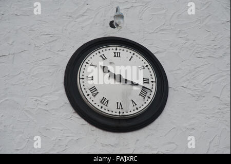 Clock on white wall Stock Photo