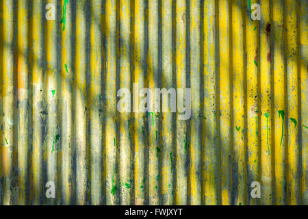 Corrugated iron wall surface background in yellow and grey. Stock Photo
