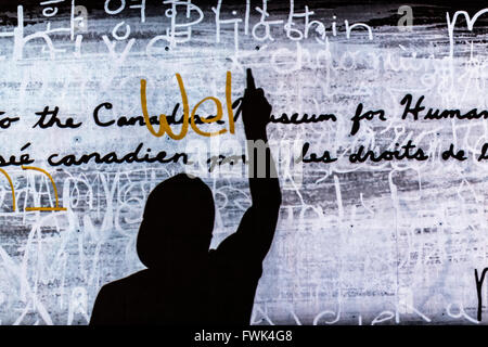 Silhouette of person writing on wall, Canadian Museum for Human Rights, Winnipeg, Manitoba, Canada. Stock Photo