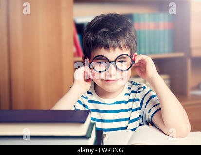 seven years old child reading a book Stock Photo