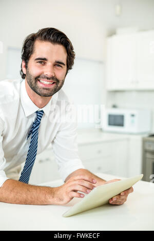 Confident businessman using digital tablet at table Stock Photo