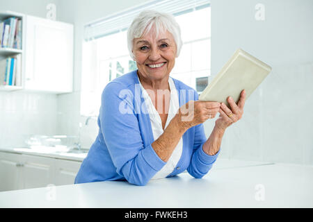 Portrait of senior woman using tablet pc Stock Photo