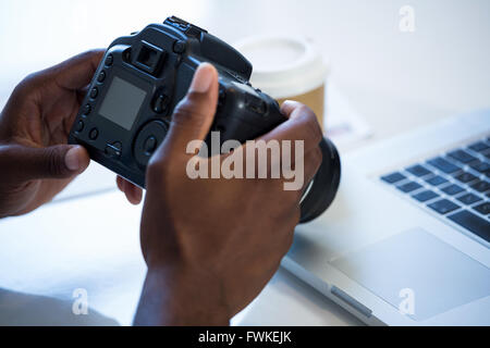 Man checking photo in camera Stock Photo