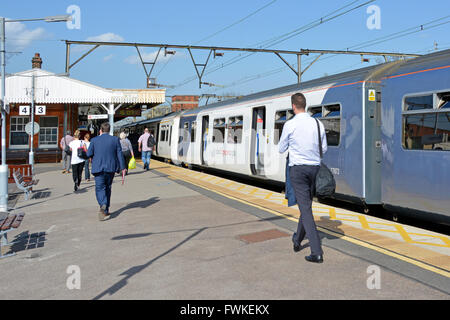 Abellio Greater Anglia commuter train at Shenfield train station with returning rail passengers walking along platform England UK Stock Photo