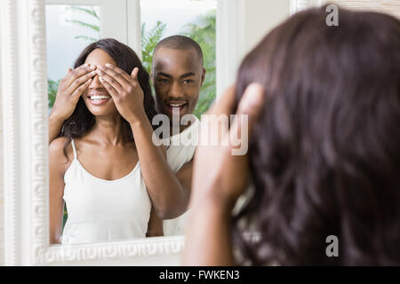 Young man covering womans eyes Stock Photo