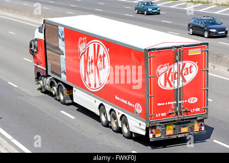 Transportation logistics Kit Kat chocolate bar & wrapper graphics on side of articulated trailer advertising product driving along uk English motorway Stock Photo