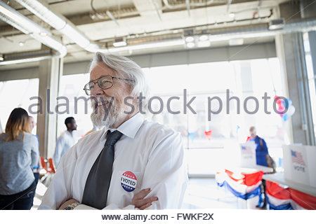 Smiling senior man at voter polling place