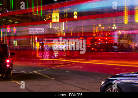 London Bus light trails night time Piccadilly circus black Cab taxi long exposure Stock Photo