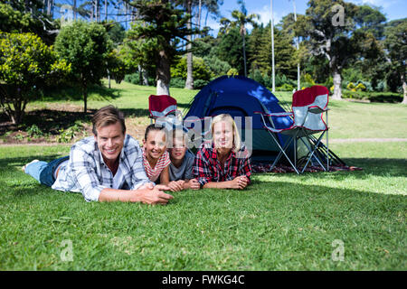 Portrait of happy family lying on grass Stock Photo