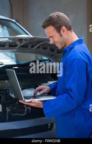 Mechanic using a laptop Stock Photo