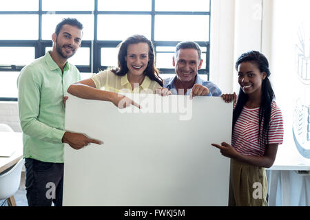 Colleagues holding blank board Stock Photo