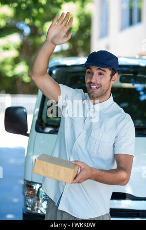 Smiling man waving hand Stock Photo